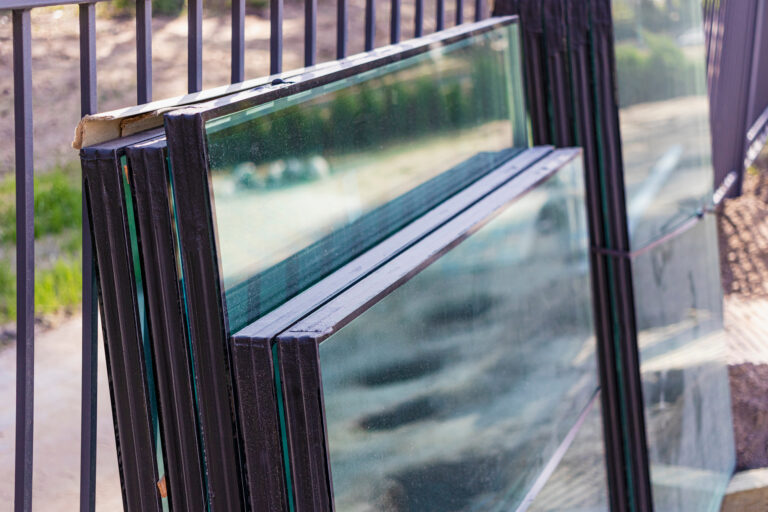 Stacked insulated glass units with black spacers and sealed edges.